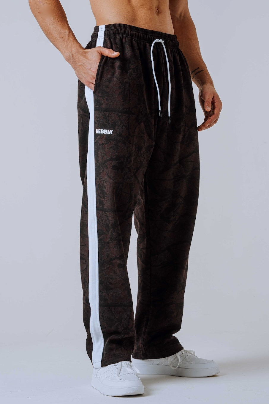 Front view of NEBBIA 904 Power Sweatpants in Black & Dark Brown Camo on a muscular model.