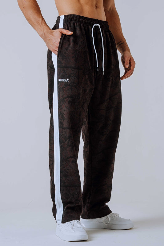 Front view of NEBBIA 904 Power Sweatpants in Black & Dark Brown Camo on a muscular model.