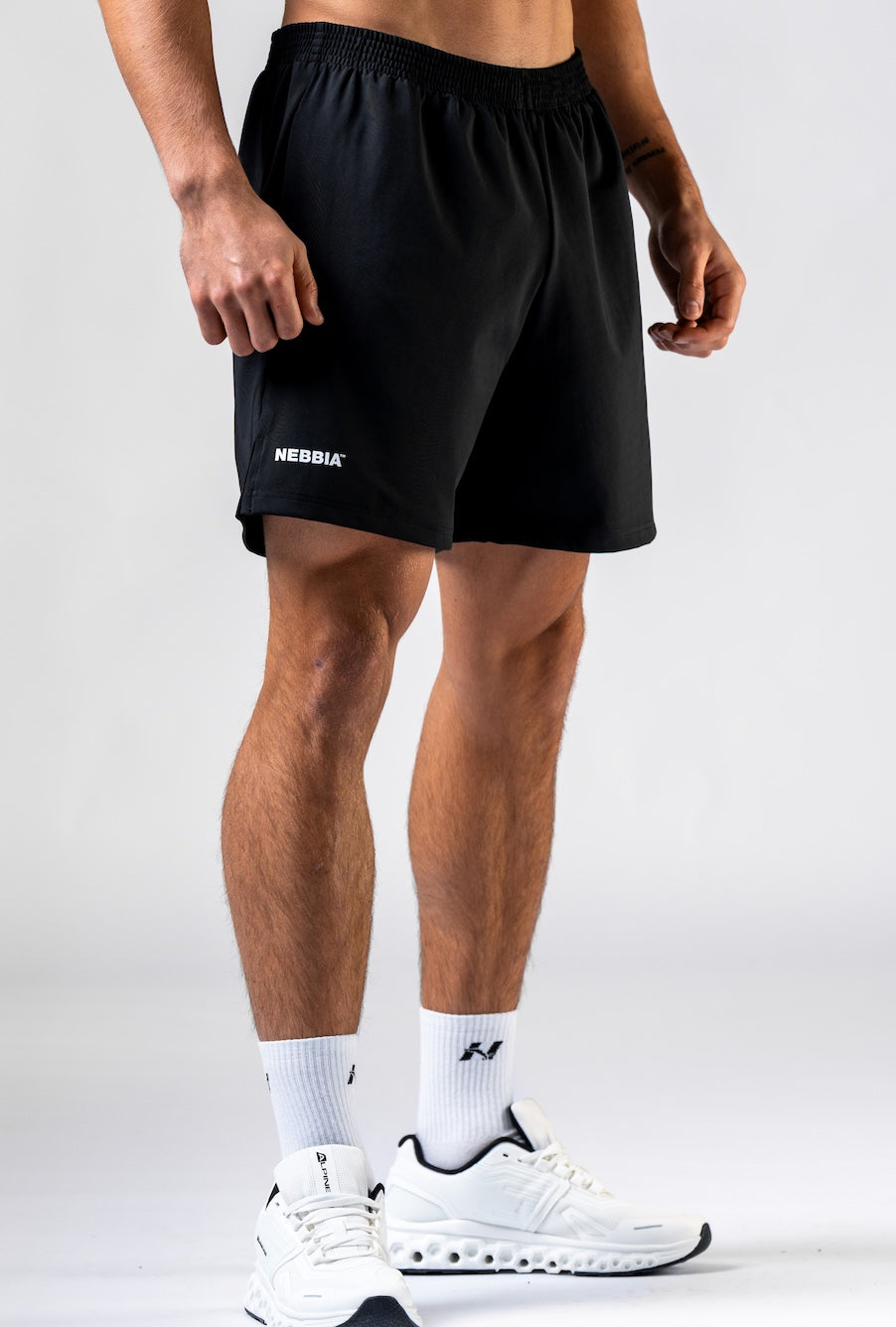 Front view of NEBBIA 902 Power Training Shorts in Black & Black on a muscular athlete.