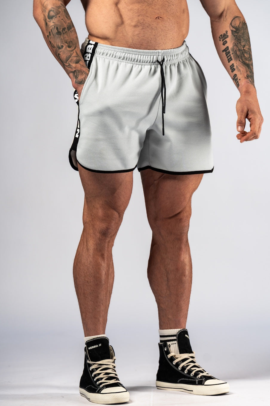 Front view of NEBBIA Hero 295 Training Shorts in Light Grey and Black, featuring iconic branded side-tapes and athletic fit.