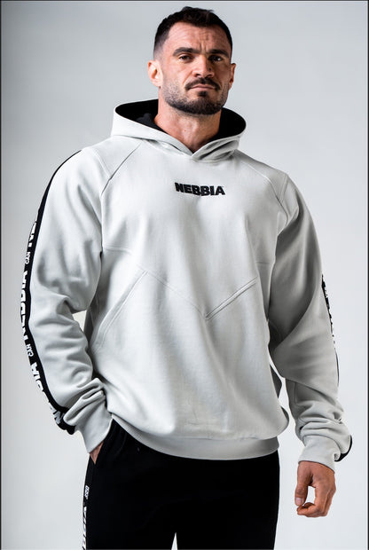 Front view of NEBBIA Hero 300 Training Hoodie in Light Grey/Black, showing the athletic silhouette and chest logo.