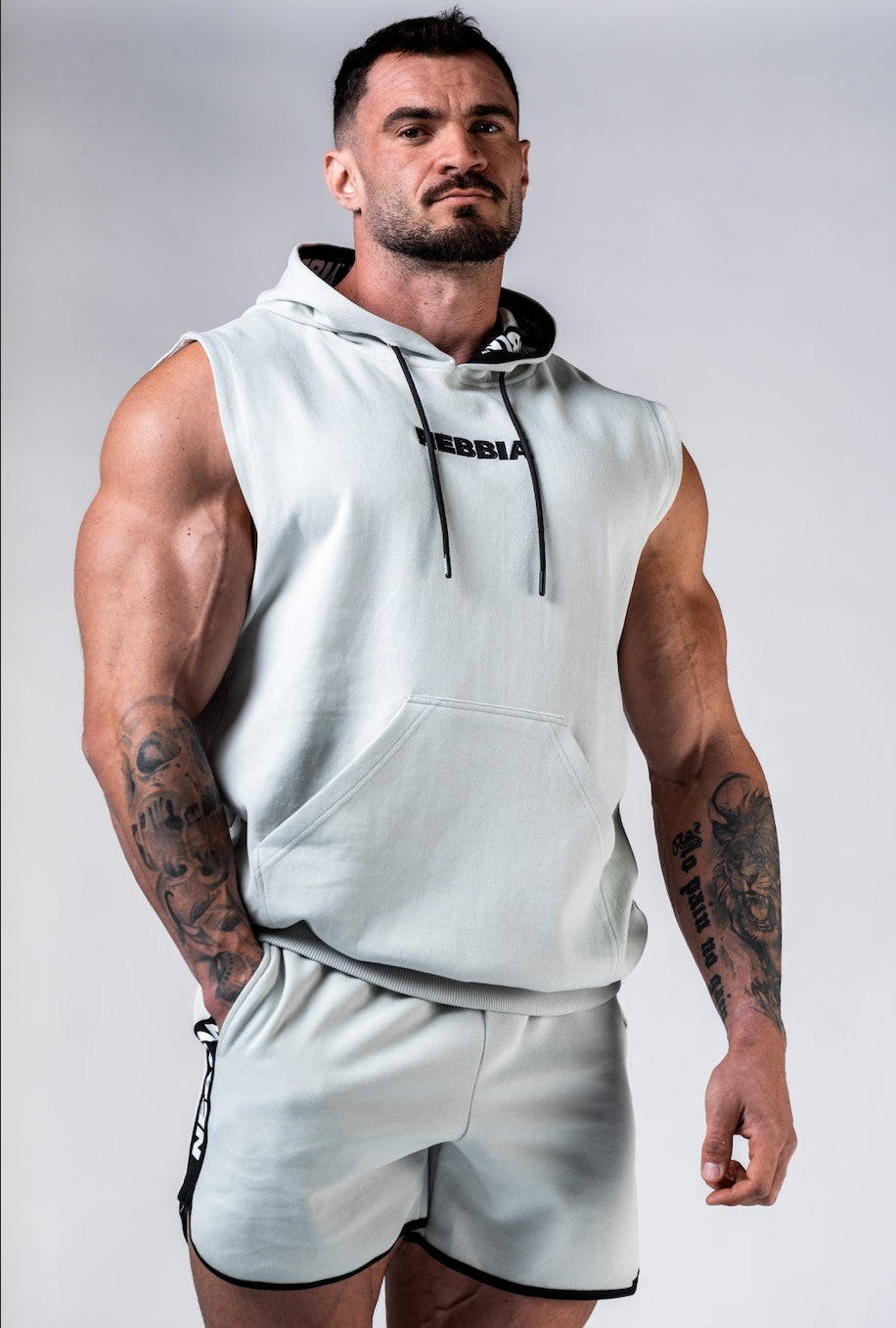 Front view of NEBBIA Hero 299 Training Tank in Light Grey/Black, showing the deep-cut sleeveless design and chest logo.