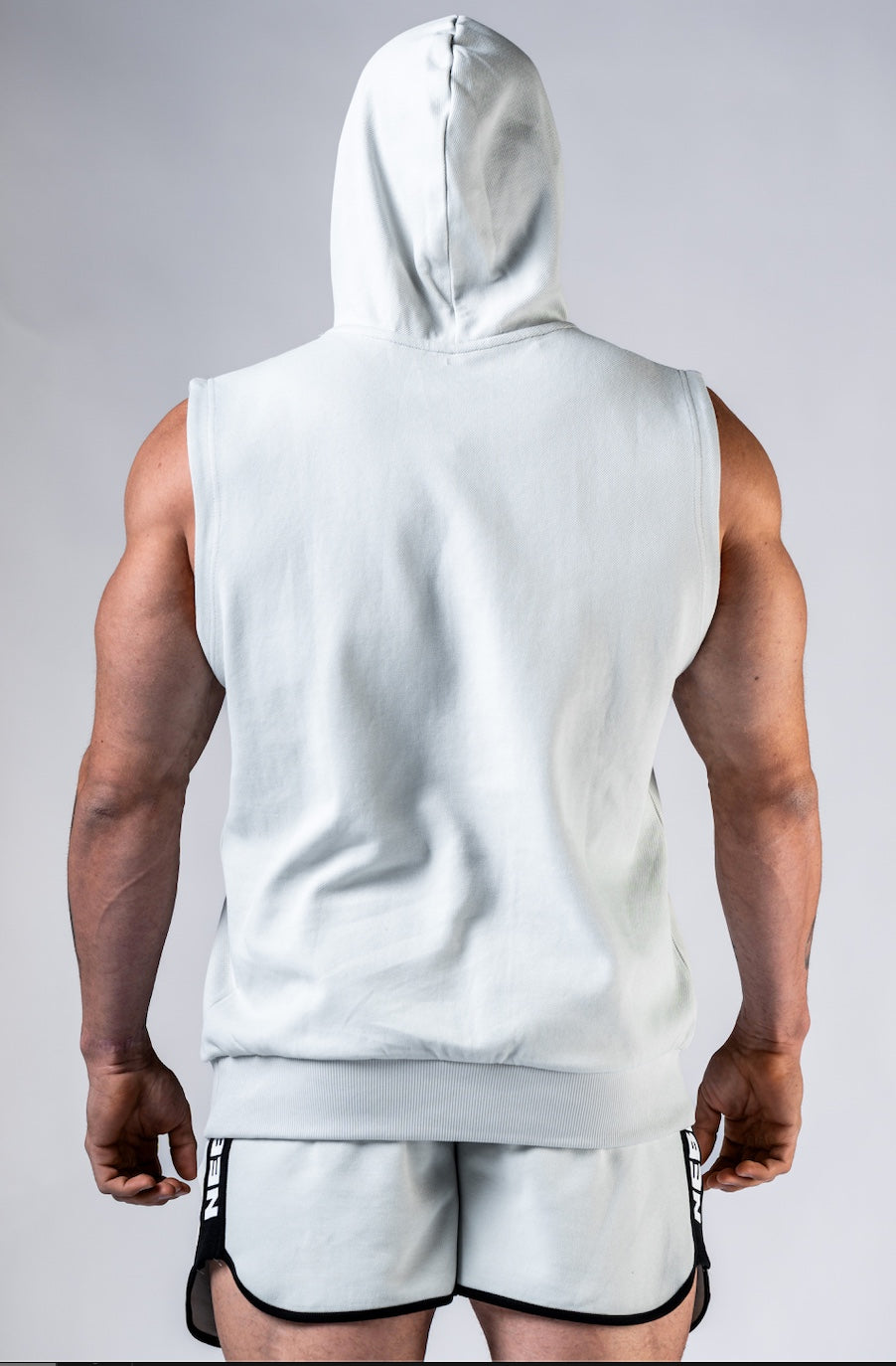Back view of the NEBBIA 299 Training Tank demonstrating the wide shoulder cut and structured hood.
