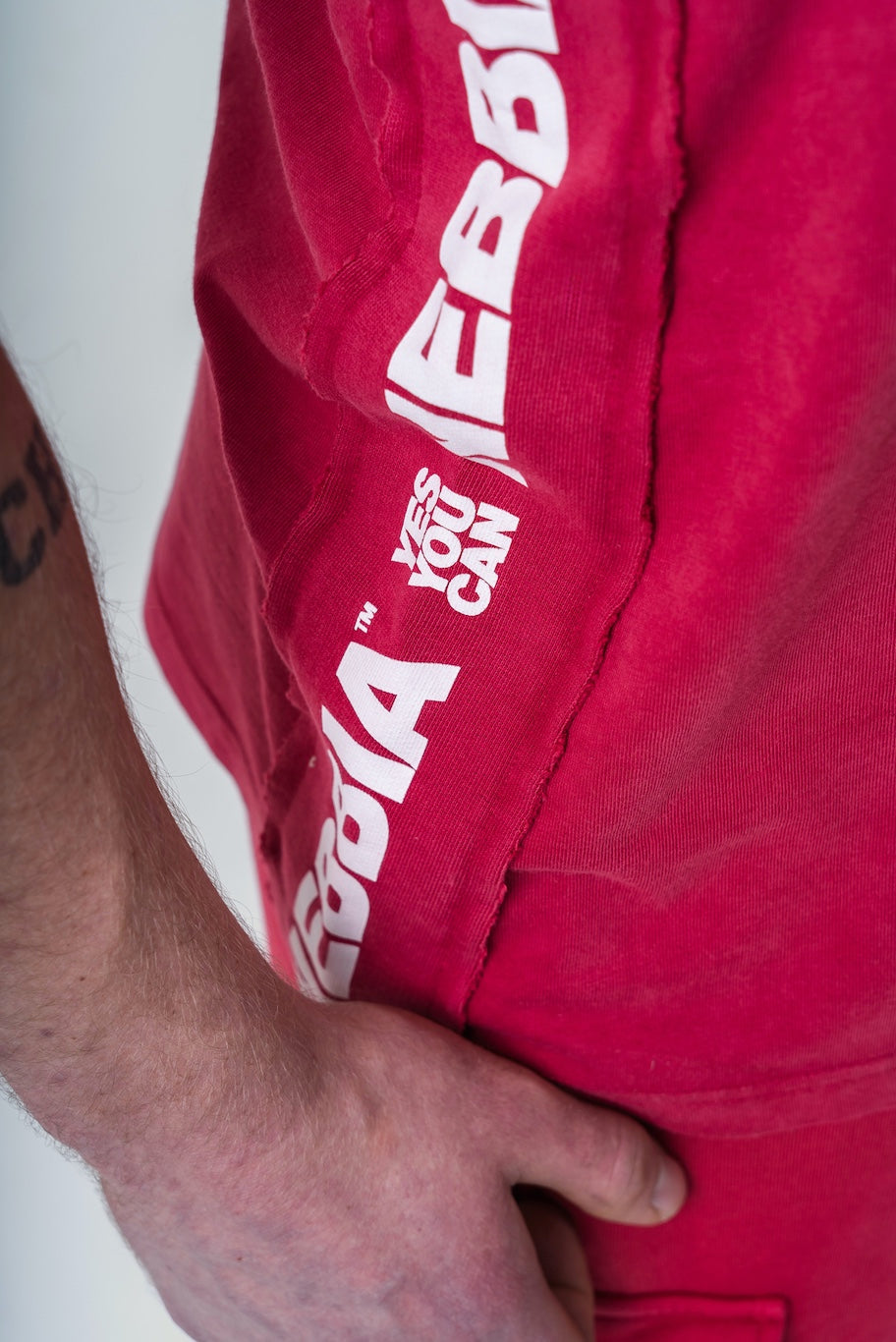 Close-up of the washed red cotton texture and the high-quality vintage NEBBIA print on the 791 stringer.