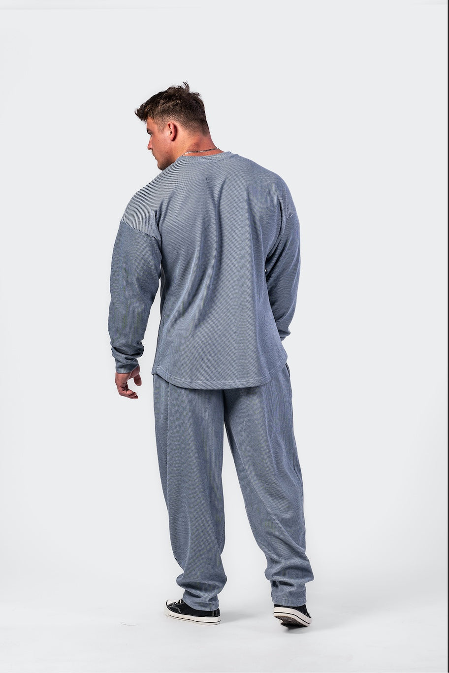 Side profile of the blue 797 pullover showing the drop-shoulder design and thick, premium fabric structure.