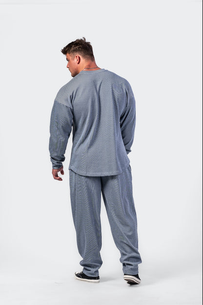 Side profile of the blue 797 pullover showing the drop-shoulder design and thick, premium fabric structure.