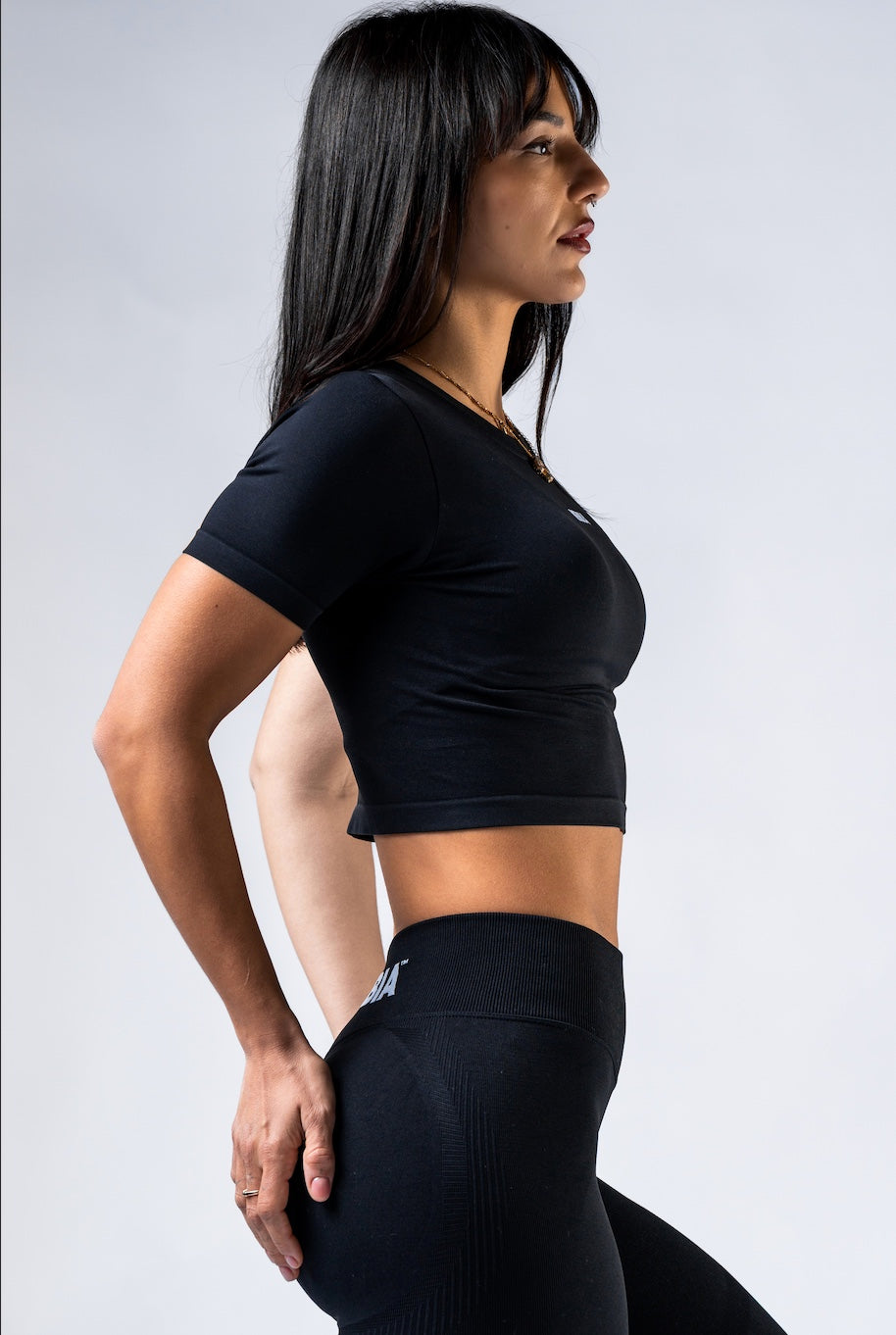 Close-up of the soft-silk fabric texture and the subtle NEBBIA logo on the black 891 top.