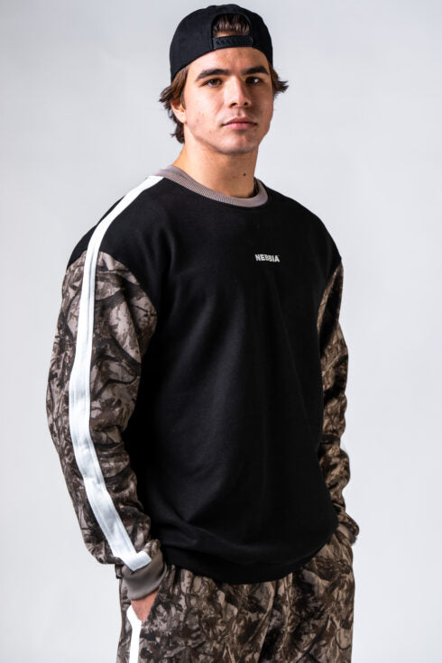 Front view of man wearing NEBBIA Relaxed Power Sweatshirt 903 in black and light brown camo