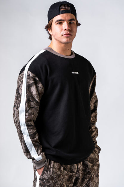 Front view of man wearing NEBBIA Relaxed Power Sweatshirt 903 in black and light brown camo